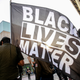 David Brown carries a Black Lives Matter flag during a march through downtown Grand Rapids, Mich., on Saturday, April 23, 2022. The march, which was organized by the Breonna Taylor Foundation,began at Veterans Park in response to the shooting death of Patrick Lyoya by a Grand Rapids police officer on April 4.